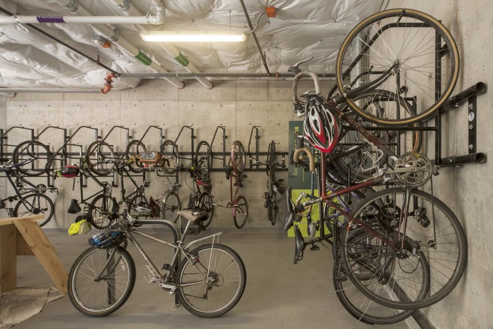 The Bullitt Center in Seattle, WA, gets people out of cars and encourages human-powered living. Bicycle commuters take full advantage of the secure covered storage provided. Image by Nic LeHoux.