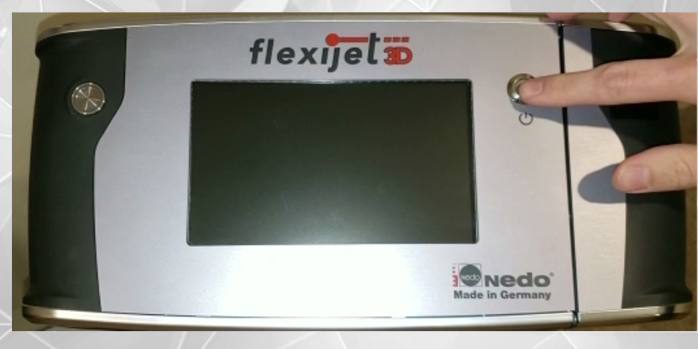 Finger pressing power button on Flexijet 3D unit